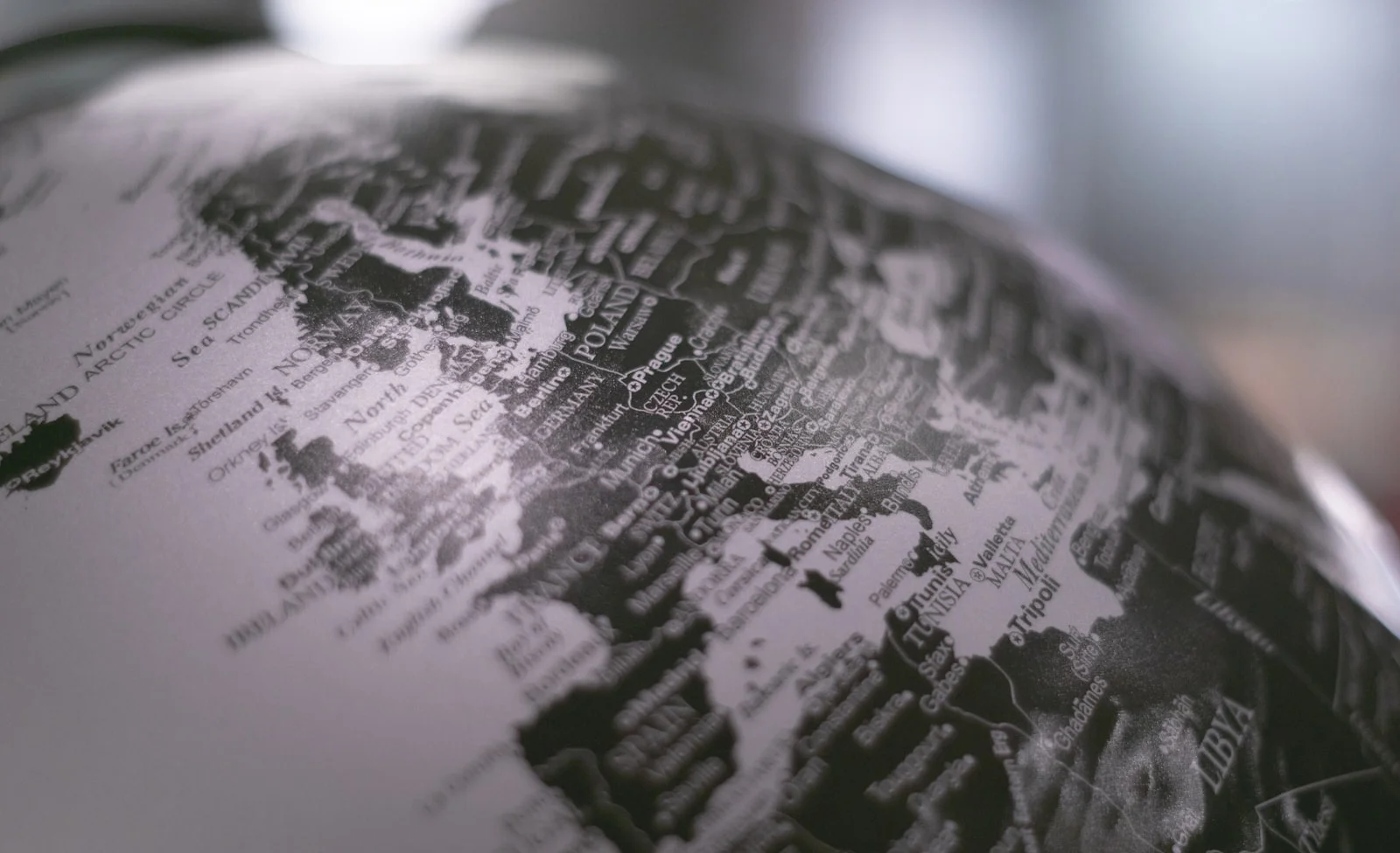 grayscale photo of desk globe grayscale photo of desk globe